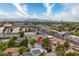 Elevated view of neighborhood featuring the property, tree coverage and distant cityscape at 5741 S Pearl St, Las Vegas, NV 89120