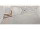 Spacious finished basement with carpet, stairs, and natural light from three windows at 5741 S Pearl St, Las Vegas, NV 89120