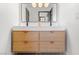 Modern bathroom vanity with double sinks, oak drawers and large, minimalist mirror at 5741 S Pearl St, Las Vegas, NV 89120