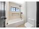 Stylish bathroom featuring a soaking tub and shower with bright, neutral-toned tiles at 5741 S Pearl St, Las Vegas, NV 89120