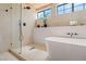 Elegant bathroom featuring a soaking tub, glass-enclosed shower, and contemporary fixtures at 5741 S Pearl St, Las Vegas, NV 89120