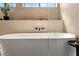 Close up shot of an elegant soaking tub and matte black plumbing fixtures at 5741 S Pearl St, Las Vegas, NV 89120