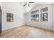 Bright bedroom with vaulted ceiling, ceiling fan, light wood floors, and large windows at 5741 S Pearl St, Las Vegas, NV 89120