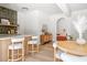 A well-lit breakfast bar with three stools, featuring a white countertop and a stylish backsplash at 5741 S Pearl St, Las Vegas, NV 89120