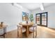 Bright dining area features wood floors, stylish chairs, a contemporary table, and exterior view at 5741 S Pearl St, Las Vegas, NV 89120