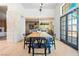 Dining room with views to the outdoor and stone column features and an open kitchen at 5741 S Pearl St, Las Vegas, NV 89120