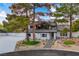 Well-maintained two story home exterior with stone accents, fresh landscaping, and an inviting walkway at 5741 S Pearl St, Las Vegas, NV 89120