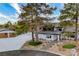 Two-story home with desert landscaping, mature trees, and an attached three-car garage at 5741 S Pearl St, Las Vegas, NV 89120
