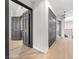 Upper hallway featuring gray doors, light flooring, and modern lighting fixtures at 5741 S Pearl St, Las Vegas, NV 89120