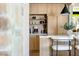 Close up of kitchen featuring barstool seating, stone accents, custom lighting, and countertop appliances at 5741 S Pearl St, Las Vegas, NV 89120