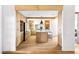 Open kitchen boasts an island with seating, wood cabinetry, stone accents, and modern lighting fixtures at 5741 S Pearl St, Las Vegas, NV 89120
