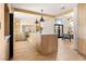 Open-concept kitchen featuring a large island, stainless steel appliances, wood cabinets, and modern lighting at 5741 S Pearl St, Las Vegas, NV 89120