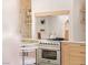A stainless steel stove and oven surrounded by stone walls and wooden cabinets at 5741 S Pearl St, Las Vegas, NV 89120