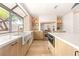 Bright kitchen featuring a large window, a farmhouse sink, and stone accent wall at 5741 S Pearl St, Las Vegas, NV 89120