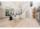 Bright living room features high ceilings, stone accent wall, and modern staircase at 5741 S Pearl St, Las Vegas, NV 89120