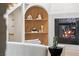 Living room showcasing a fireplace and archway shelving with decorative accents at 5741 S Pearl St, Las Vegas, NV 89120