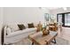 Bright living room with a comfortable white sofa, modern coffee table, and natural light at 5741 S Pearl St, Las Vegas, NV 89120