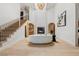 Spacious living room with fireplace, open staircase, modern lighting, and hardwood floors at 5741 S Pearl St, Las Vegas, NV 89120