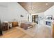 Spacious main bedroom with hardwood floors, fireplace, private balcony, and wooden panel ceiling at 5741 S Pearl St, Las Vegas, NV 89120