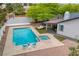 Aerial view of a backyard featuring a private pool and spa, lounging area, and lush greenery at 5741 S Pearl St, Las Vegas, NV 89120