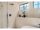 Modern shower with rain shower head and handheld sprayer, with a plant on the shelf at 5741 S Pearl St, Las Vegas, NV 89120