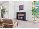 Sitting room showcasing a fireplace, accent art, and large windows for natural light at 5741 S Pearl St, Las Vegas, NV 89120