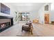 Bright sitting room featuring a fireplace, large windows, and comfortable seating at 5741 S Pearl St, Las Vegas, NV 89120