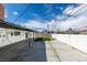 View of the backyard shows a concrete area, artificial turf, and white exterior of the home at 5800 Balzar Ave, Las Vegas, NV 89108