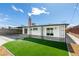 Spacious backyard with artificial turf, a covered patio, and mature landscaping at 5800 Balzar Ave, Las Vegas, NV 89108