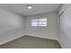 Neutral bedroom with new gray carpet and window at 5800 Balzar Ave, Las Vegas, NV 89108