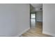 Hallway featuring light wood flooring and a view of the outdoor patio, creating a bright and open atmosphere at 5800 Balzar Ave, Las Vegas, NV 89108