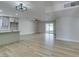 Spacious open-concept living space with light wood flooring, a ceiling fan, and backyard access at 5800 Balzar Ave, Las Vegas, NV 89108