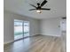 The naturally lit living room features wood-look flooring and a sliding glass door that opens to the backyard at 5800 Balzar Ave, Las Vegas, NV 89108