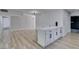 Open floor plan with wood-style flooring, cabinet with drawers, and modern lighting at 5800 Balzar Ave, Las Vegas, NV 89108