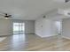 Open living room with wood-look floors and sliding doors to the outdoor space at 5800 Balzar Ave, Las Vegas, NV 89108
