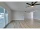 Open living room featuring wood-look floors, a ceiling fan, and sliding glass doors at 5800 Balzar Ave, Las Vegas, NV 89108