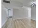 Spacious living area with light wood floors, neutral walls, and modern lighting at 5800 Balzar Ave, Las Vegas, NV 89108