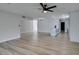 Open floor plan with wood-look flooring that seamlessly connects the living room to the kitchen at 5800 Balzar Ave, Las Vegas, NV 89108