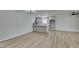 Expansive living space featuring wood-look flooring, a breakfast bar, and ample room for dining and lounging at 5800 Balzar Ave, Las Vegas, NV 89108