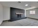 Living room featuring a black brick fireplace, a wooden mantel, and cozy carpeting at 5800 Balzar Ave, Las Vegas, NV 89108