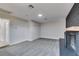 Spacious living room features neutral paint, gray carpet and a brick fireplace at 5800 Balzar Ave, Las Vegas, NV 89108