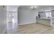 Bright and spacious open-concept area featuring wood-look flooring and access to the entryway and kitchen at 5800 Balzar Ave, Las Vegas, NV 89108