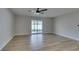 Sun-filled living room boasts wood-look floors and a sliding glass door that leads to the backyard at 5800 Balzar Ave, Las Vegas, NV 89108