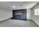 Spacious carpeted living room with brick fireplace and ample natural light from the window at 5800 Balzar Ave, Las Vegas, NV 89108