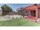 Well-maintained backyard with a red canopy, patio area, synthetic grass, and rock landscaping at 6236 Tierra Cove St, North Las Vegas, NV 89081