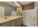 Bright bathroom featuring a double sink vanity with modern fixtures and a shower-tub combination at 6236 Tierra Cove St, North Las Vegas, NV 89081