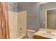 Bathroom featuring a shower-tub combination, toilet, sink with vanity and gray colored walls at 6236 Tierra Cove St, North Las Vegas, NV 89081
