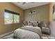 Inviting bedroom featuring soft natural light from a large window, plush bedding, and tranquil decor at 6236 Tierra Cove St, North Las Vegas, NV 89081