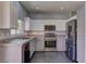 Well-lit kitchen featuring granite counters, stainless steel appliances, and ample cabinet space at 6236 Tierra Cove St, North Las Vegas, NV 89081