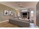 Staged living room with modern furniture, neutral tones, sleek ceiling fan and a stylish fireplace at 6236 Tierra Cove St, North Las Vegas, NV 89081